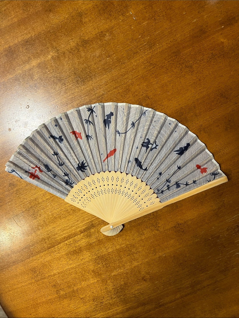 Traditional Handheld Folding Fan with Blue and Red Fish Design
